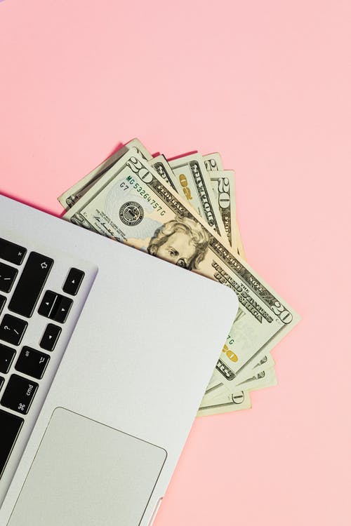 10 Us Dollar Bill Beside Macbook Pro